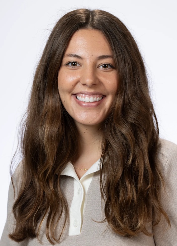 Portrait of Emily Gutzwiller, woman with long brown hair and a grey shirt.
