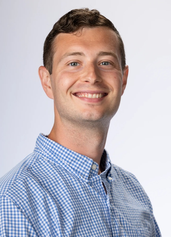 Portrait of Jackson Gamer, man with short brown hair and a blue shirt.