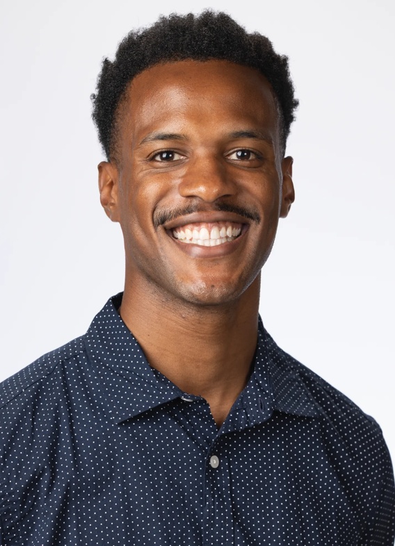 Portrait of Jonathan Joseph, man with short black hair and a dark blue shirt.