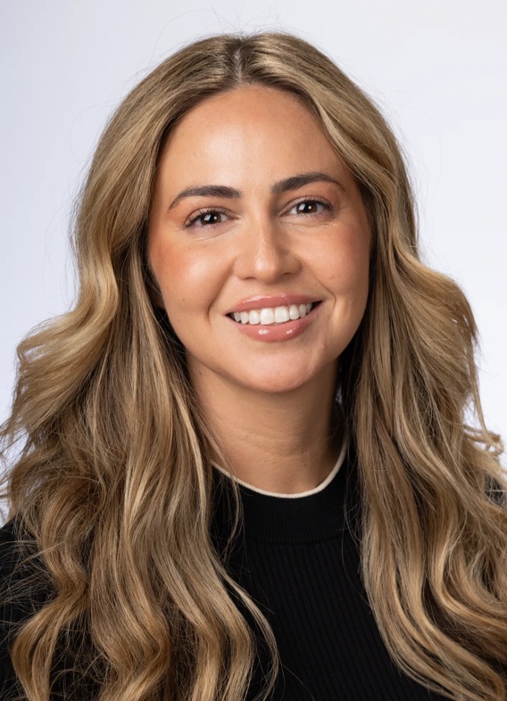 Portrait of Julia D'Isabella, woman with long blonde hair and a black shirt.