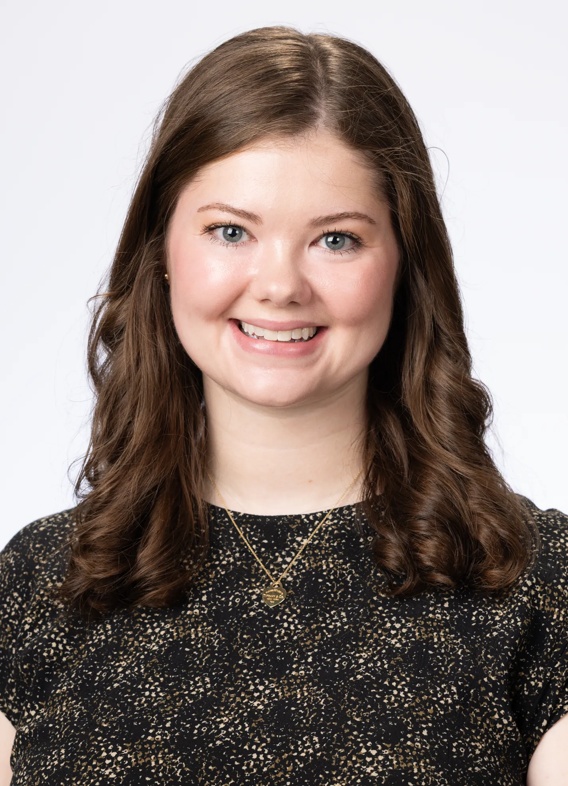 Portrait of Kelsey Klamar, woman with long brown hair and a black shirt.