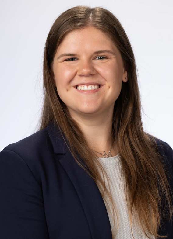 Portrait of Megan Seyerle, woman with long brown hair and a black blazer