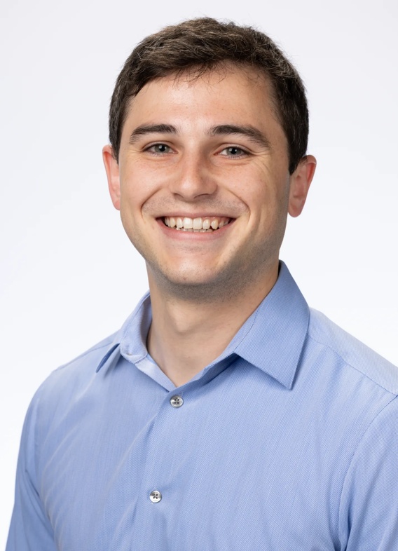 Portrait of Nicholas Iovino, man with short brown hair and a blue shirt.