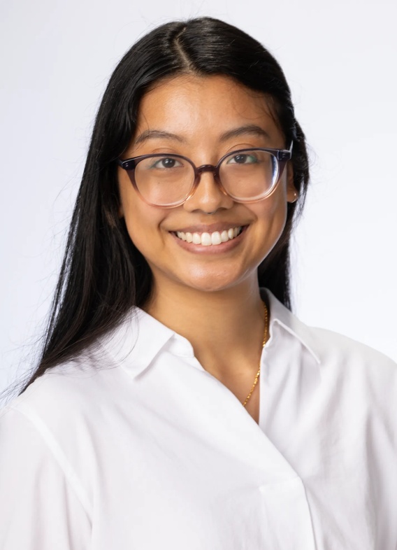 Portrait of Rosa Soto, woman with long black hair and a white shirt.