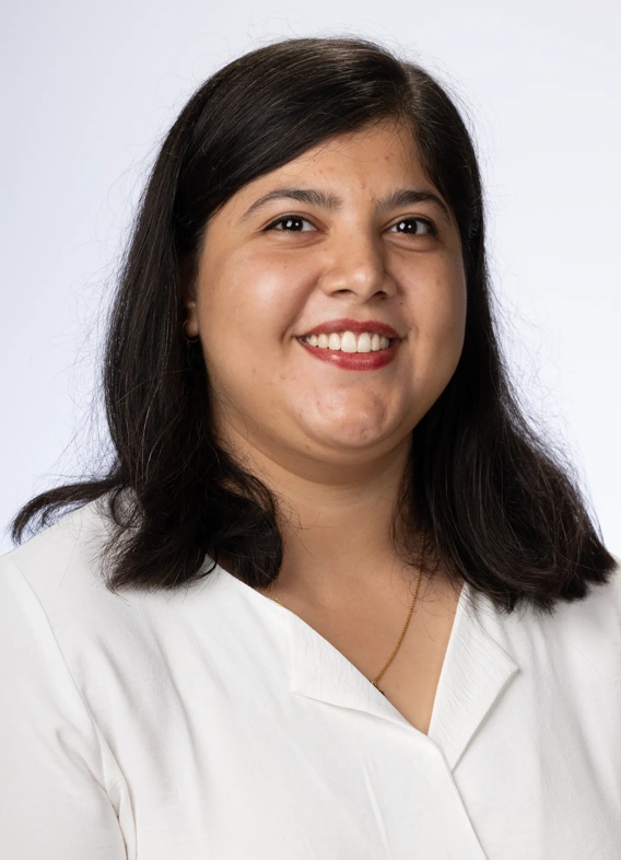 Portrait of Shameen Bhutto, woman with short black hair and a white shirt.