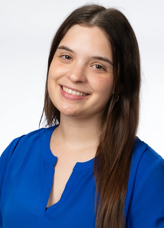 Portrait of Alejandra Diaz, woman with long brown hair and a blue shirt.