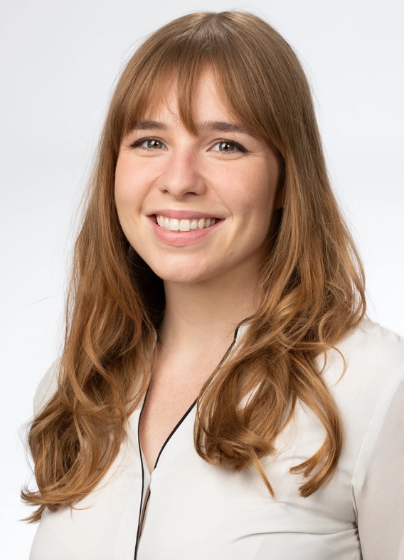 Portrait of Ashley Flaquer, woman with blond hair and a white shirt.