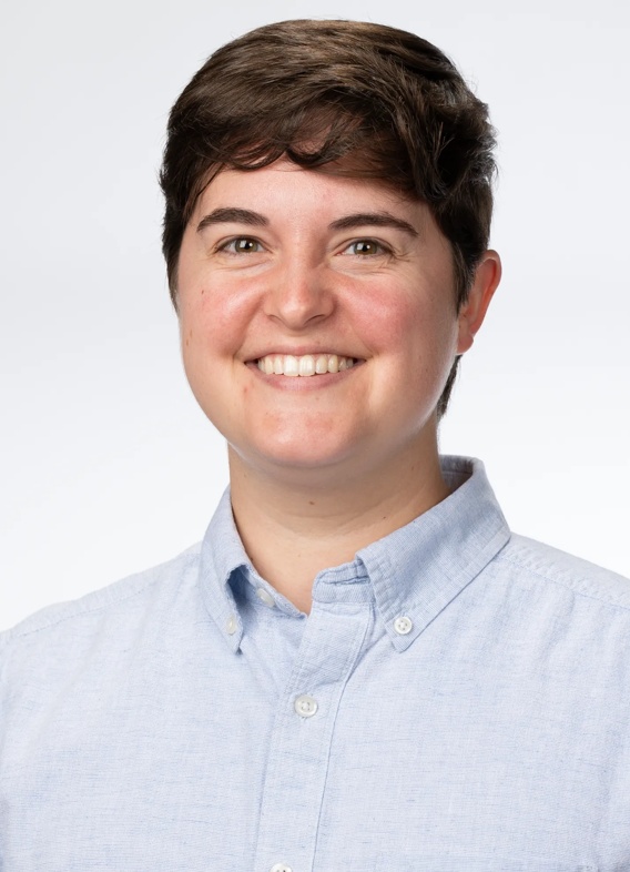Portrait of Bennett Moss, man with short brown hair and a light blue shirt.
