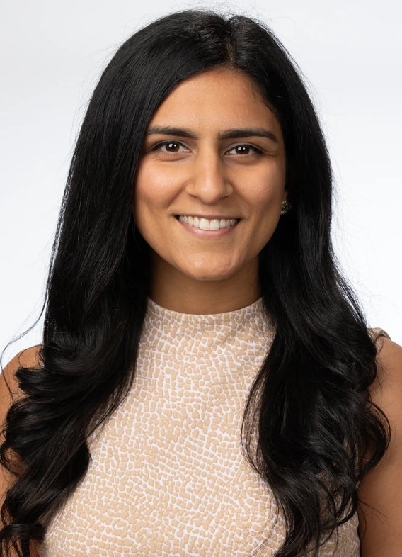 Portrait of Bhuvna Mahajan, woman with long black hair and a light brown shirt.