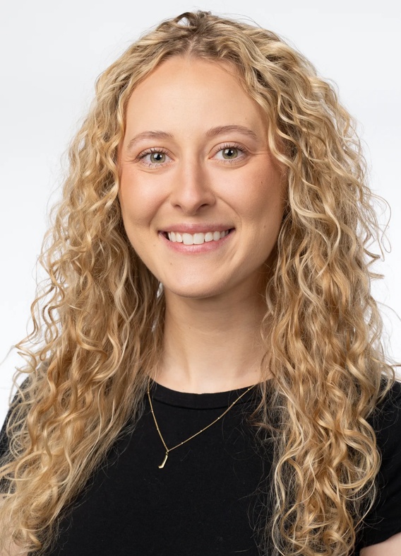 Portrait of Cara Shurilla, woman with long blonde hair and a black shirt.