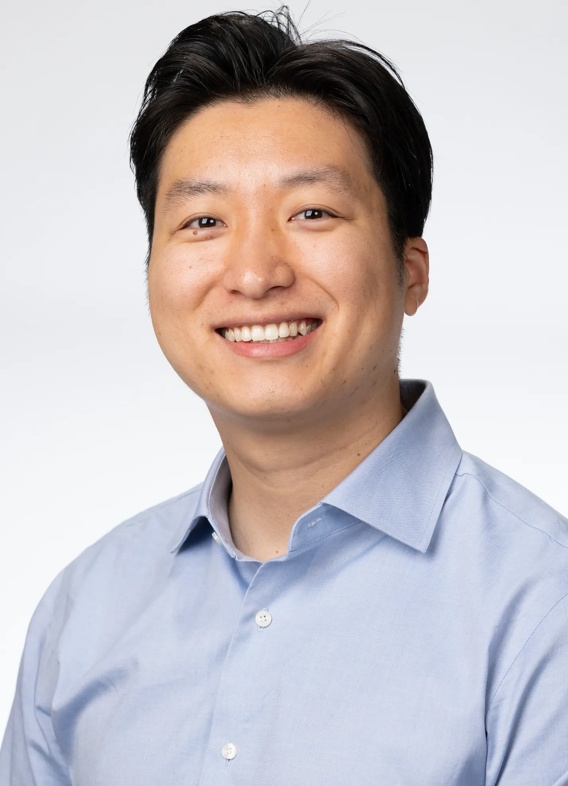 Portrait of Dennis Yang, man with short black hair and a light blue shirt.