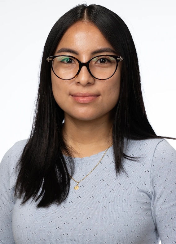 Portrait of Elizabeth Ramos Orosco, woman with long black hair and a grey shirt.