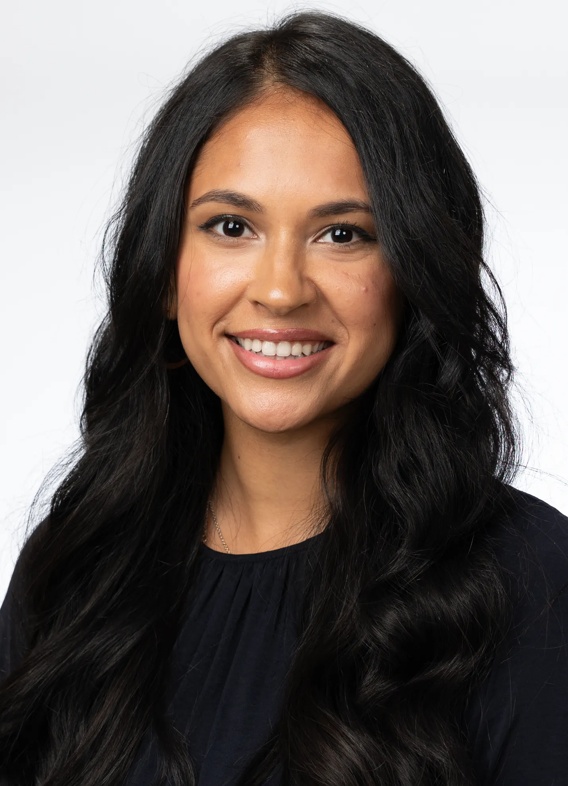Portrait of Henna Patel, woman with long black hair and a black shirt.