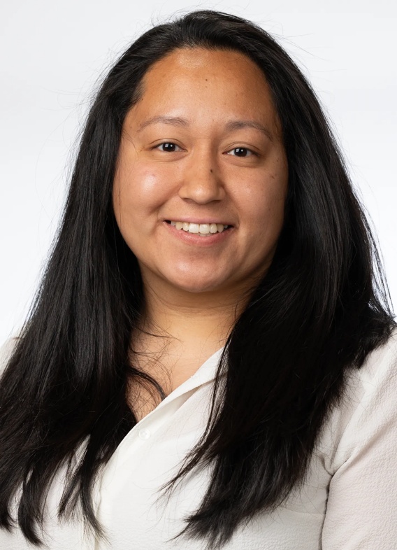 Portrait of Jamie Hernandez, a woman with long black hair and a white shirt.