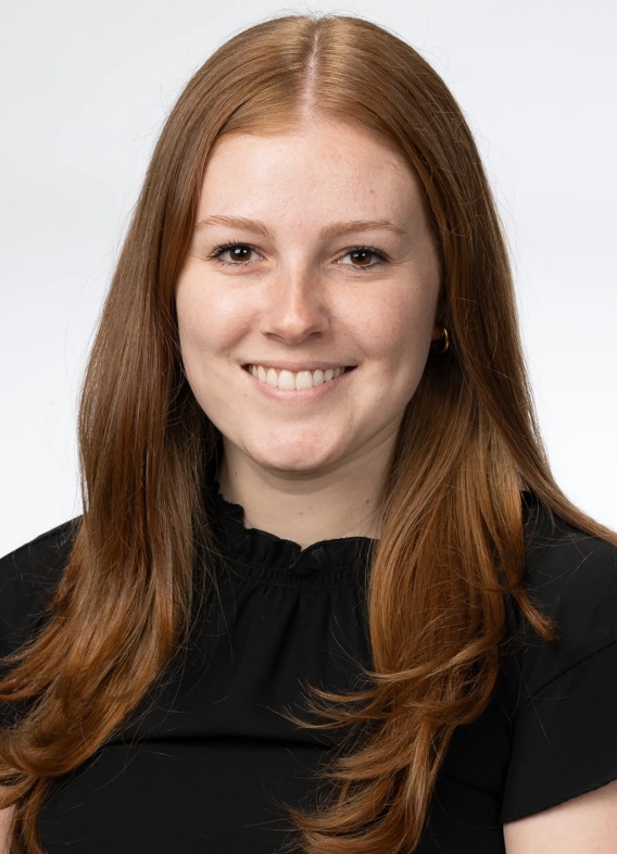 Portrait of Jessica Edwards, woman with long red hair and a black shirt.