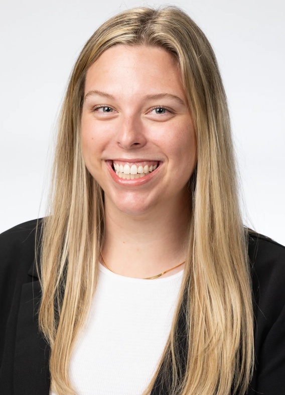 Portrait of Joanna Rebitski, woman with long blonde hair and a black shirt.