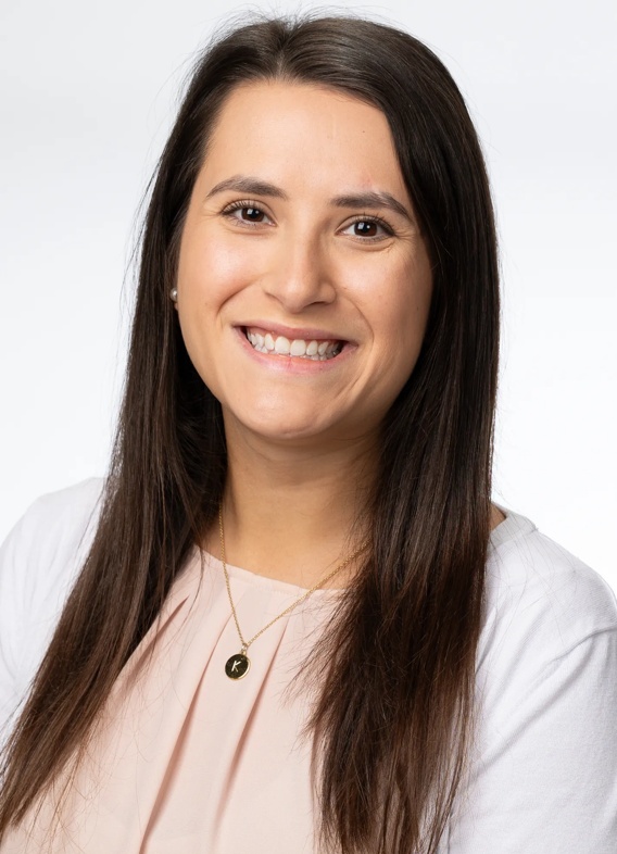 Portrait of Kathryn Kimsey, woman with long brown hair and a light pink shirt.