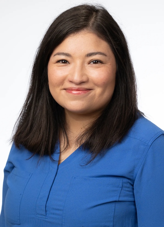 Portrait of Maria Carrasco, woman with short black hair and a blue shirt.