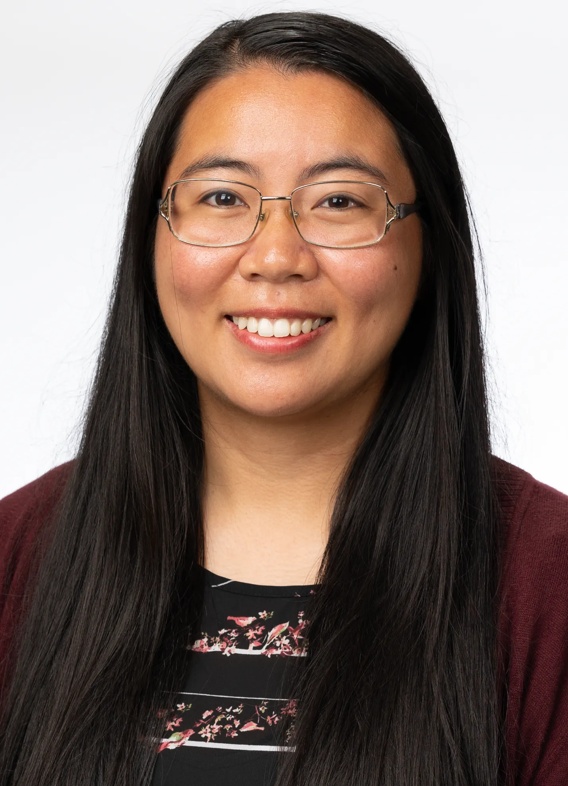 Portrait of Roselle Bea Almazan, woman with long black hair, glasses, and a red shirt.