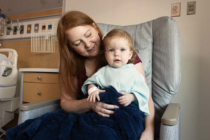 baby girl in mom's lap at hospital