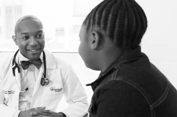 Dr. Bignall and patient in exam room