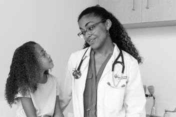 Dr. Delerme and patient in exam room