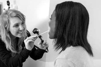 Female resident examining a female teen patient