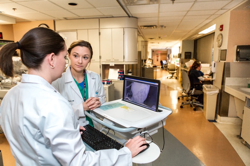 Two female residents discussing a case