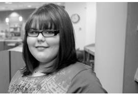 Tween Girl Reading Book In a Library