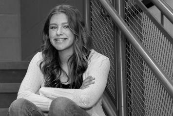 Teen girl sitting on steps smiling