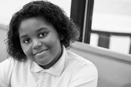 Smiling young girl in cafeteria