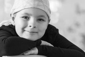 Young smiling cancer patient wearing head wrap