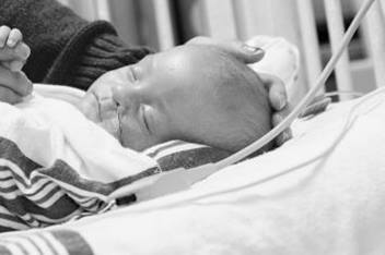 NICU baby in isolette