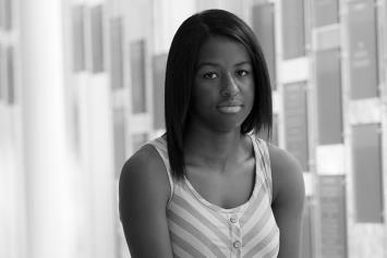 Teenage Girl Looking Somber in Hallway