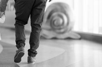 Toddler Walking in Hallway Holding Dad's Hand