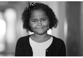 Young Girl Smiling in Hallway