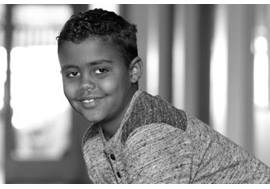 Young Boy Smiling in Hallway