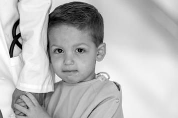 Young Boy Holding Physician Hand