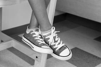 Sneaker dangling off exam room table