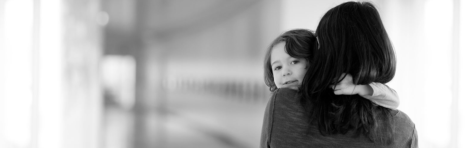 Son Looking Over Mom's Shoulder