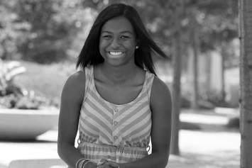 Teenage Girl Smiling and Sitting Outside