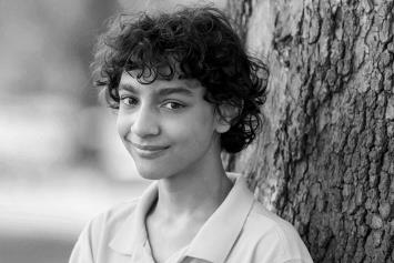 Pre Teen Boy Standing by a Tree