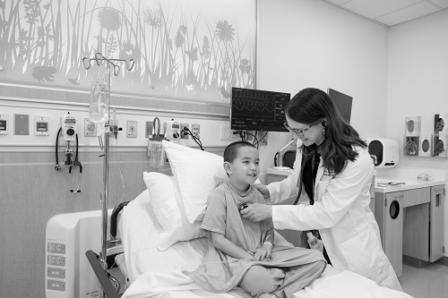 fellow listening to patient's heartbeat