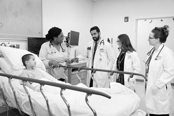 hospital medicine team working with patient