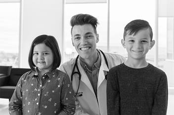 Doctor and two children smiling