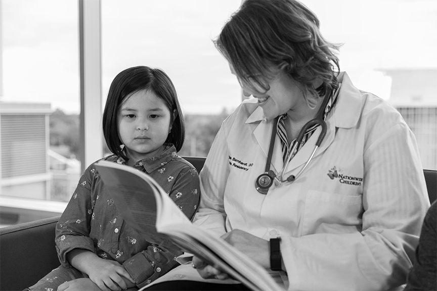 Doctor reading book to child 
