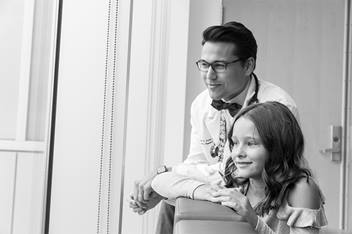 Doctor and patient look out windows