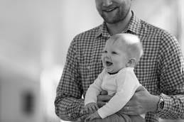 Infant Son Smiling in Dad's Lap