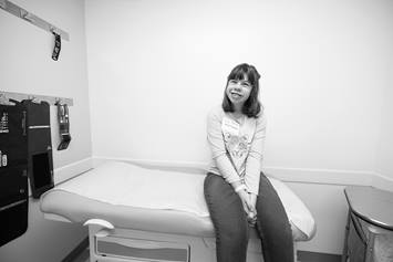 Young adolescent with Williams syndrome sitting in patient room of hospital.