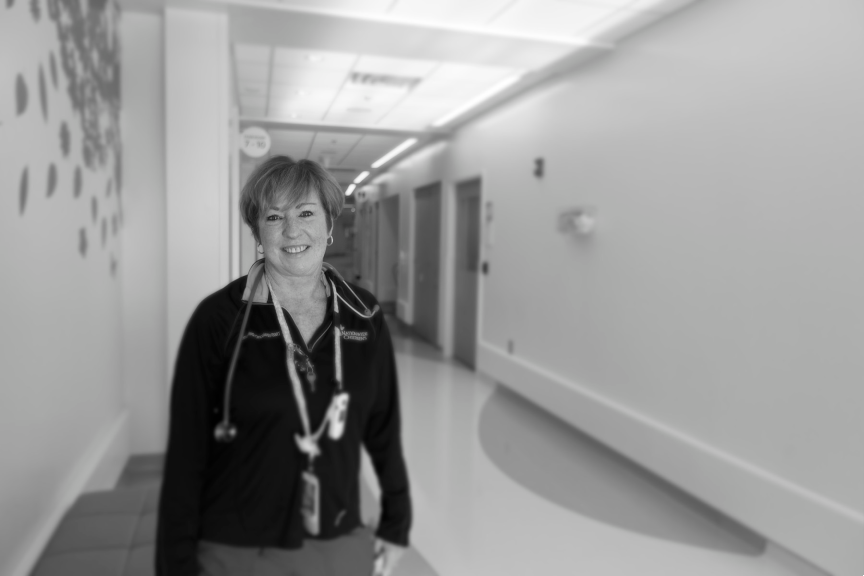 Maureen, Clinical Leader, standing in hallway